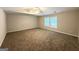 A carpeted bedroom with neutral walls and natural light coming in from the two windows at 3814 Clear Lake Nw Way, Acworth, GA 30101