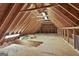 Spacious unfinished attic with exposed wooden beams and lighting, ideal for storage or conversion at 209 Smokerise Trce, Peachtree City, GA 30269