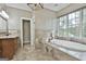 Bathroom featuring a soaking tub with jets, a tile floor, and a marble vanity at 209 Smokerise Trce, Peachtree City, GA 30269