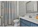 Bathroom features a stylish vanity, patterned wallpaper, and a shower with a neutral curtain at 209 Smokerise Trce, Peachtree City, GA 30269