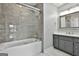 Bathroom features a shower and tub combination with gray tiling and a white vanity at 209 Smokerise Trce, Peachtree City, GA 30269