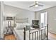 Cozy bedroom features a metal frame bed with throw pillows and gleaming hardwood floors at 209 Smokerise Trce, Peachtree City, GA 30269
