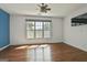 Large bedroom with hardwood floors, ceiling fan, and bright natural light from big window at 209 Smokerise Trce, Peachtree City, GA 30269