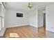 Spacious bedroom with hardwood floors, ceiling fan, and a television mounted on the wall at 209 Smokerise Trce, Peachtree City, GA 30269