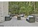 Spacious outdoor deck with comfortable seating and wooded view, perfect for entertaining at 209 Smokerise Trce, Peachtree City, GA 30269