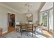 Formal dining room with chandelier, hardwood floors, and view to bar area at 209 Smokerise Trce, Peachtree City, GA 30269