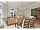Dining room with decorative chandelier and a view to the home's entrance and wet bar at 209 Smokerise Trce, Peachtree City, GA 30269