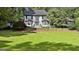 Charming two-story home with a well-manicured lawn, brick exterior, and lots of shade trees at 209 Smokerise Trce, Peachtree City, GA 30269