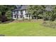 Charming two-story home with a well-manicured lawn, brick exterior, and mature tree coverage at 209 Smokerise Trce, Peachtree City, GA 30269