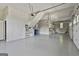 Spacious garage interior with ample storage, work bench, and peg board perfect for the handy person at 209 Smokerise Trce, Peachtree City, GA 30269