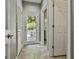 Hallway showcasing tile flooring, decorative wallpaper and access to the outdoor deck at 209 Smokerise Trce, Peachtree City, GA 30269