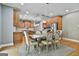 Spacious kitchen and dining area with stainless steel appliances, wood cabinets, and designer lighting at 209 Smokerise Trce, Peachtree City, GA 30269