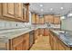 Gourmet kitchen with granite countertops, custom cabinets, and stainless steel appliances at 209 Smokerise Trce, Peachtree City, GA 30269
