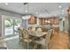 Open kitchen and dining area with wood floors, stainless steel appliances, and a sliding glass door at 209 Smokerise Trce, Peachtree City, GA 30269