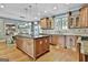 Spacious kitchen featuring custom cabinets, granite countertops, tile backsplash, and stainless steel appliances at 209 Smokerise Trce, Peachtree City, GA 30269