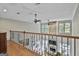 Upper level view of living room with fireplace and large windows, showcasing an open concept at 209 Smokerise Trce, Peachtree City, GA 30269