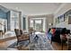 Spacious living room featuring large bay window, hardwood floors, and adjacent entryway at 209 Smokerise Trce, Peachtree City, GA 30269