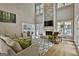 Well-lit living room featuring a stone fireplace, two story windows, and hardwood floors at 209 Smokerise Trce, Peachtree City, GA 30269