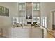 Bright and airy living room features a stone fireplace, many windows, and French doors leading to a deck at 209 Smokerise Trce, Peachtree City, GA 30269