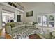 Large living room with a view into the upstairs balcony featuring an oversized sectional and patterned rug at 209 Smokerise Trce, Peachtree City, GA 30269