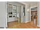 Spacious living room with a stone fireplace, wood floors, and an open concept design leading into the kitchen at 209 Smokerise Trce, Peachtree City, GA 30269