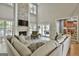 Inviting living room with stone fireplace and an open floor plan looking to the outdoor patio at 209 Smokerise Trce, Peachtree City, GA 30269