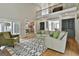 Bright open living room with wood floors, a second story balcony, and views into the dining room at 209 Smokerise Trce, Peachtree City, GA 30269