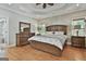 Relaxing primary bedroom with a wooden bed frame, hardwood floors, and natural light at 209 Smokerise Trce, Peachtree City, GA 30269