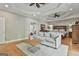 Spacious primary bedroom with a seating area, hardwood floors, and decorative tray ceiling at 209 Smokerise Trce, Peachtree City, GA 30269