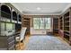 Spacious office featuring custom built-in bookshelves, desk, and large window at 209 Smokerise Trce, Peachtree City, GA 30269