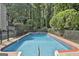 Full swimming pool view fenced in with mature trees in the background at 209 Smokerise Trce, Peachtree City, GA 30269
