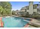A refreshing in-ground pool with diving board, set against a backdrop of a well-maintained home at 209 Smokerise Trce, Peachtree City, GA 30269