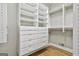 Functional walk-in closet features built-in shelving, drawers, and hardwood floors at 209 Smokerise Trce, Peachtree City, GA 30269