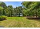 Expansive backyard with mature trees, offering serene privacy and potential lake views at 255 Mcintosh Estates Dr, Sharpsburg, GA 30277