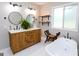 Elegant bathroom boasts a dual sink vanity, stylish fixtures, a soaking tub, and open shelving at 255 Mcintosh Estates Dr, Sharpsburg, GA 30277