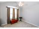 Cozy bedroom with neutral carpet, ceiling fan, and natural light from a large window with curtains at 255 Mcintosh Estates Dr, Sharpsburg, GA 30277