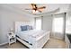 Charming bedroom with a white bed frame, tray ceiling, neutral walls, and natural light at 255 Mcintosh Estates Dr, Sharpsburg, GA 30277