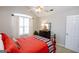 Comfortable bedroom features a high ceiling, large window with curtains, and a decorative mirror at 255 Mcintosh Estates Dr, Sharpsburg, GA 30277