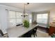 Well-lit dining area with traditional chandelier, large table, and plenty of natural light at 255 Mcintosh Estates Dr, Sharpsburg, GA 30277