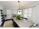 Bright dining room featuring a classic chandelier, hardwood flooring, and ample natural light at 255 Mcintosh Estates Dr, Sharpsburg, GA 30277
