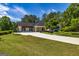 Well-maintained home with extended driveway and an attached pergola-covered outdoor space at 255 Mcintosh Estates Dr, Sharpsburg, GA 30277