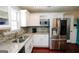 Bright kitchen with stainless steel appliances, granite countertops, and white cabinetry at 255 Mcintosh Estates Dr, Sharpsburg, GA 30277