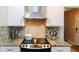 Close up on a well-equipped kitchen with granite counters, stainless appliances and white cabinetry at 255 Mcintosh Estates Dr, Sharpsburg, GA 30277