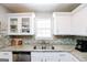 Stylish kitchen featuring granite countertops, stainless steel appliances, and white cabinets at 255 Mcintosh Estates Dr, Sharpsburg, GA 30277