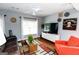 Cozy living room with an accent rug, entertainment center, ceiling fan, and unique decor at 255 Mcintosh Estates Dr, Sharpsburg, GA 30277