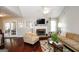 Comfortable living room features stone fireplace, hardwood floors, and a vaulted ceiling at 255 Mcintosh Estates Dr, Sharpsburg, GA 30277