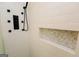 Custom tile shower with modern shower panel, hand held sprayer, and a convenient, built-in mosaic tiled niche at 255 Mcintosh Estates Dr, Sharpsburg, GA 30277