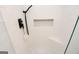Modern walk-in shower featuring white tile, a corner seat, and a built-in niche at 255 Mcintosh Estates Dr, Sharpsburg, GA 30277