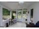 Bright sunroom with tile flooring, ceiling fan, and views of the private, landscaped backyard and patio at 255 Mcintosh Estates Dr, Sharpsburg, GA 30277