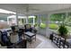 Bright sunroom with tile flooring, ceiling fan, and views of the private, landscaped backyard and patio at 255 Mcintosh Estates Dr, Sharpsburg, GA 30277